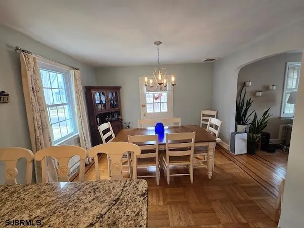 a table room with furniture a window and a chandelier