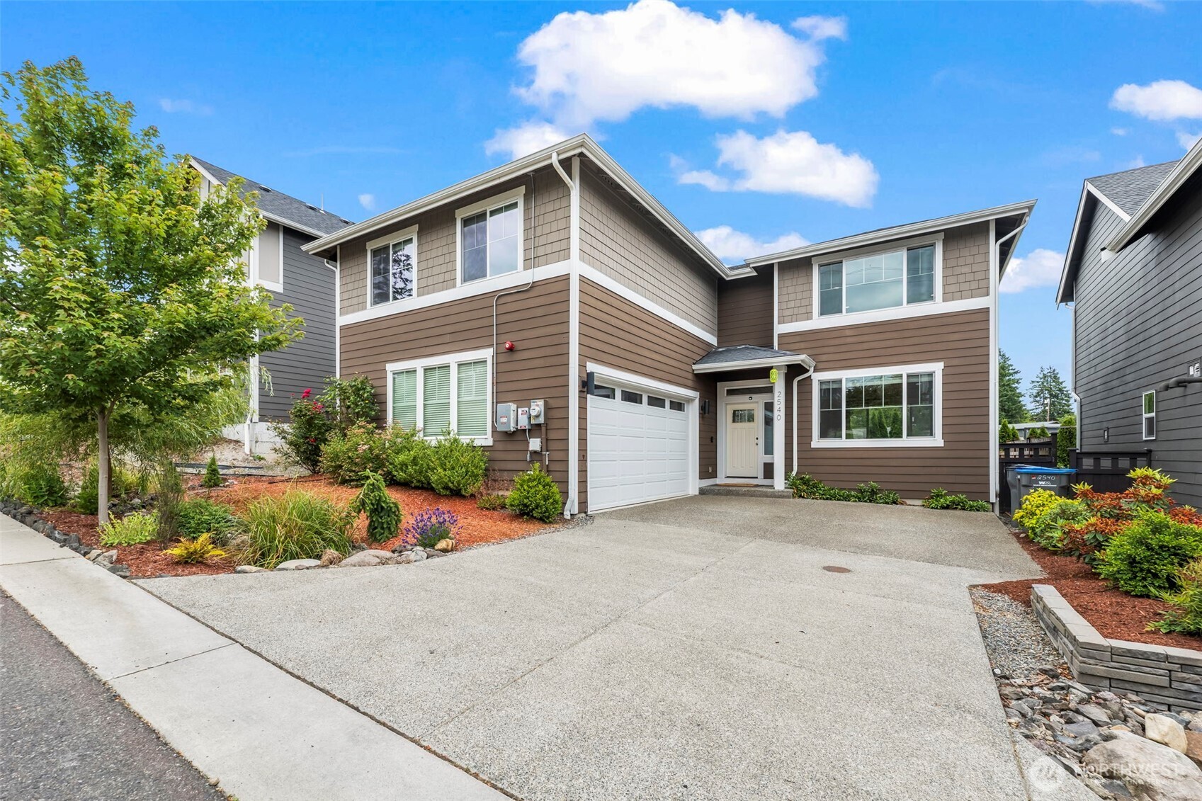 a front view of a house with garden