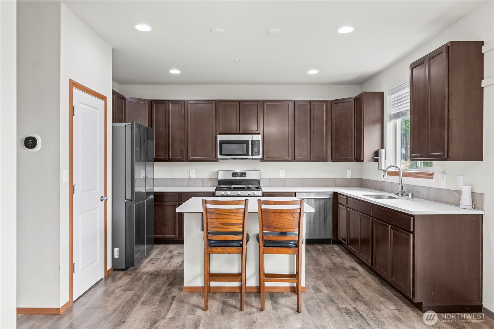 2540 Filbert Avenue Bremerton, WA 98310 - Photo 11 of 28 a kitchen with stainless steel appliances granite countertop a refrigerator and a stove top oven