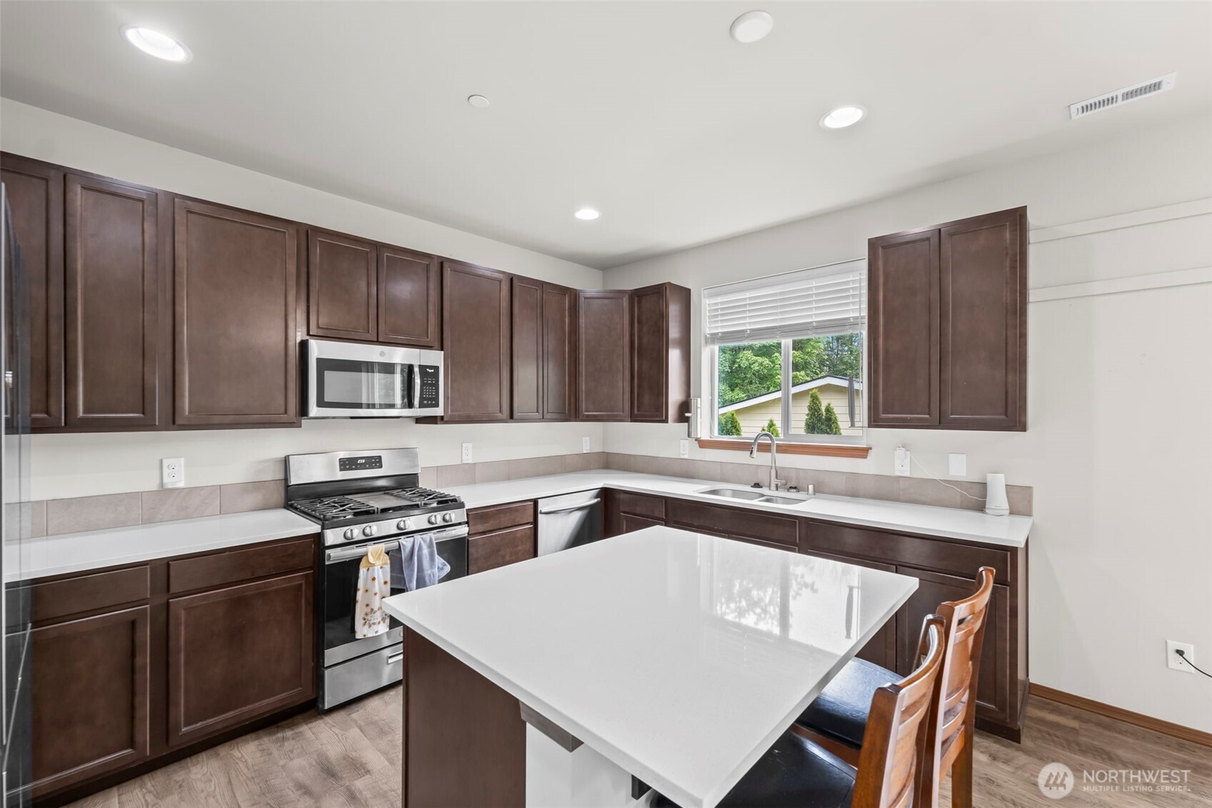 2540 Filbert Avenue Bremerton, WA 98310 - Photo 13 of 28 a kitchen with stainless steel appliances granite countertop a sink stove and refrigerator