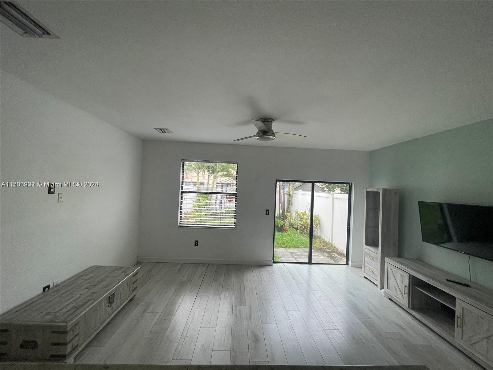 8905 West 35th Way Hialeah, FL 33018 - Photo 4 of 4 wooden floor in an empty room with a window