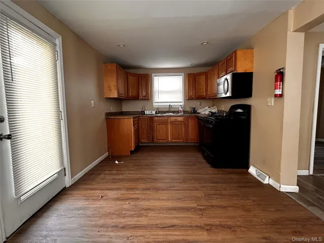 a kitchen with stainless steel appliances granite countertop a refrigerator a stove top oven a sink and dishwasher