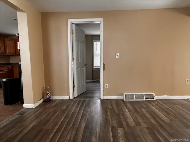 a view of a room with wooden floor and closet