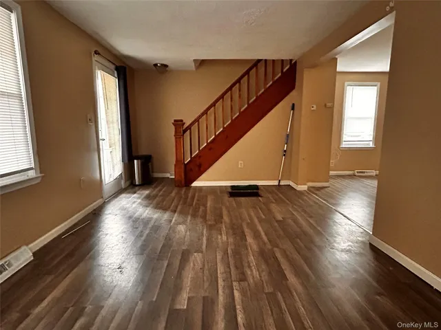 a view of entryway with wooden floor