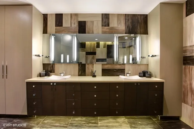 a bathroom with a double vanity sink and mirror