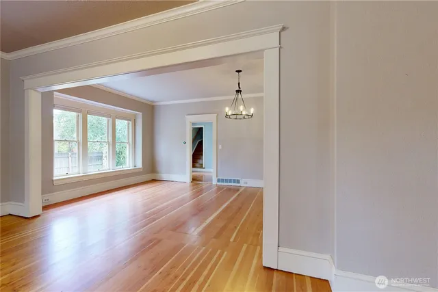 a view of a room with wooden floor and window