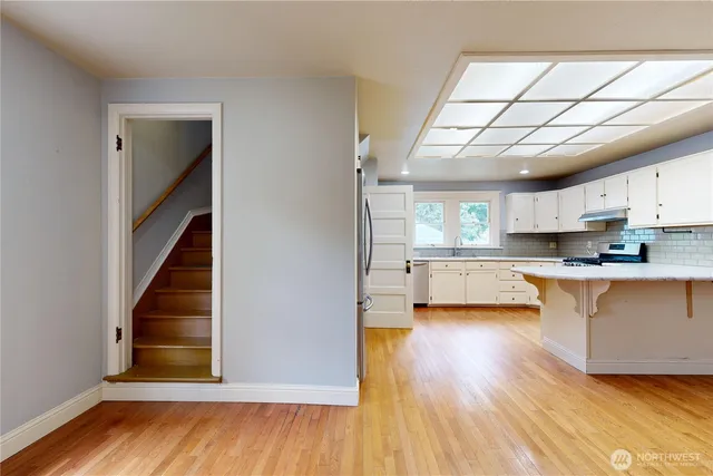 a view of a kitchen with wooden floor and a kitchen