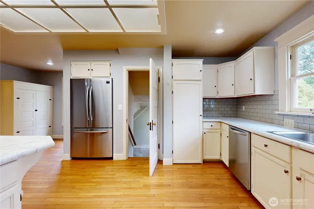 a kitchen with refrigerator and window