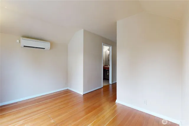a view of a room with wooden floor