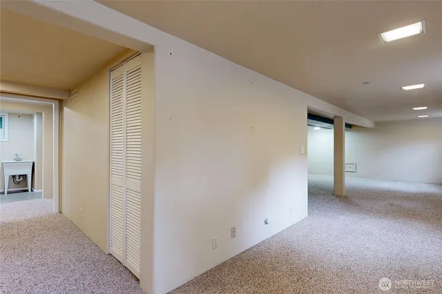 an empty room with a closet and mirrors