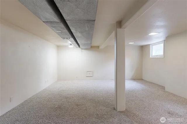 a view of a house with a yard and large tree