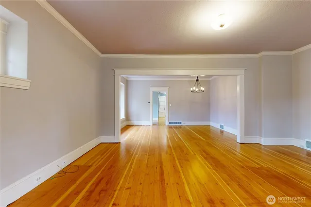 a view of a room with wooden floor