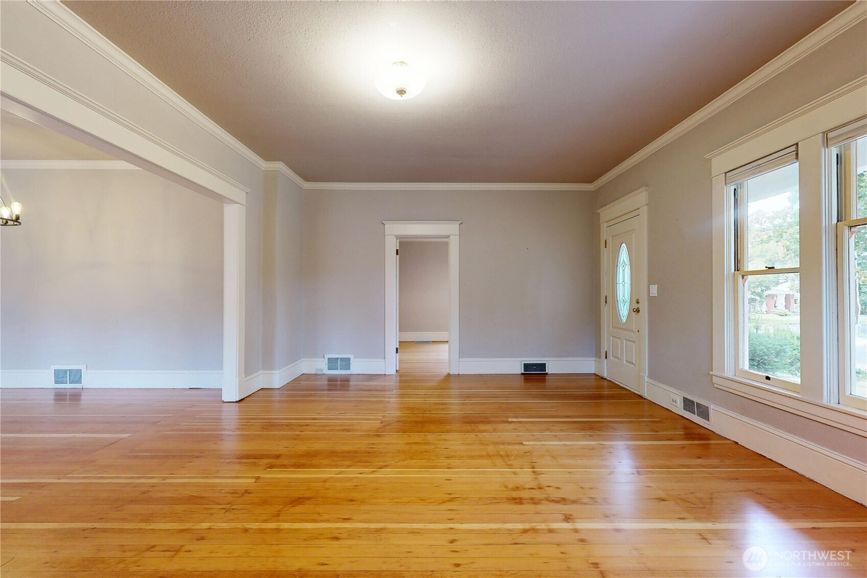 308 Newell Street Walla Walla, WA 99362 - Photo 7 of 40 a view of empty room with window and wooden floor