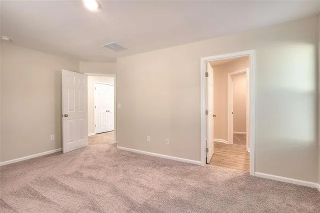a view of an empty room and closet area