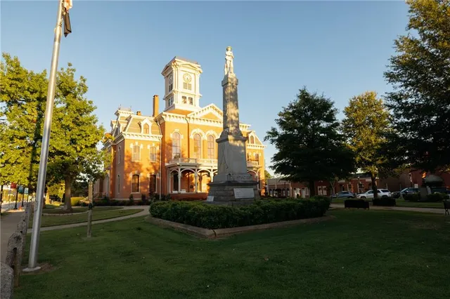 a front view of a building with trees