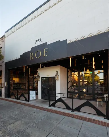 a view of a patio with a table and chairs under an umbrella