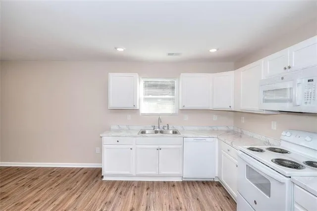 a kitchen with a sink stove and cabinets