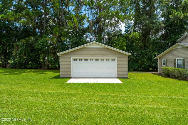 a view of an house with backyard space and garden