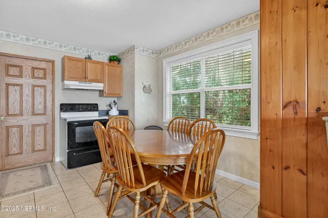 a dining room with furniture and window