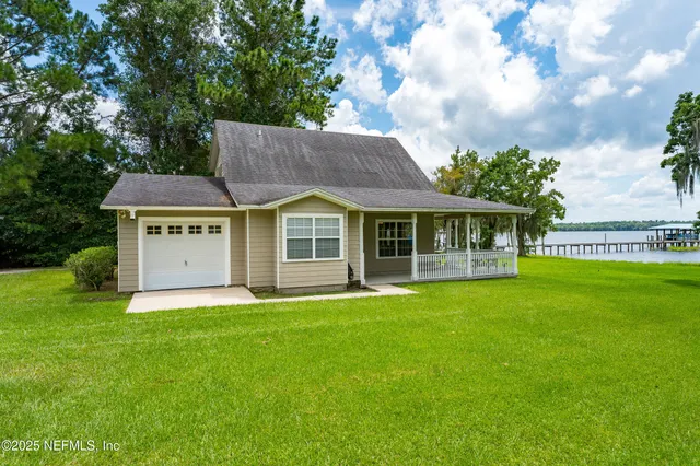 a view of an house with backyard space and balcony