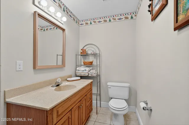 a bathroom with a sink a toilet and shower curtain