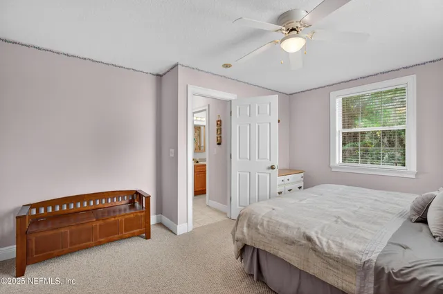 a bedroom with a bed and a lamp