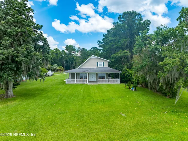 an aerial view of a house with a yard