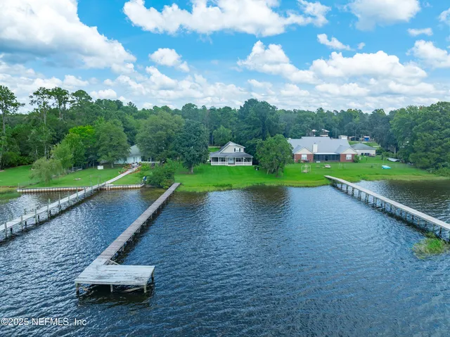 a view of a lake with a yard and lake view