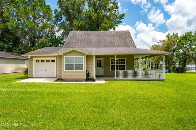 a front view of a house with a garden