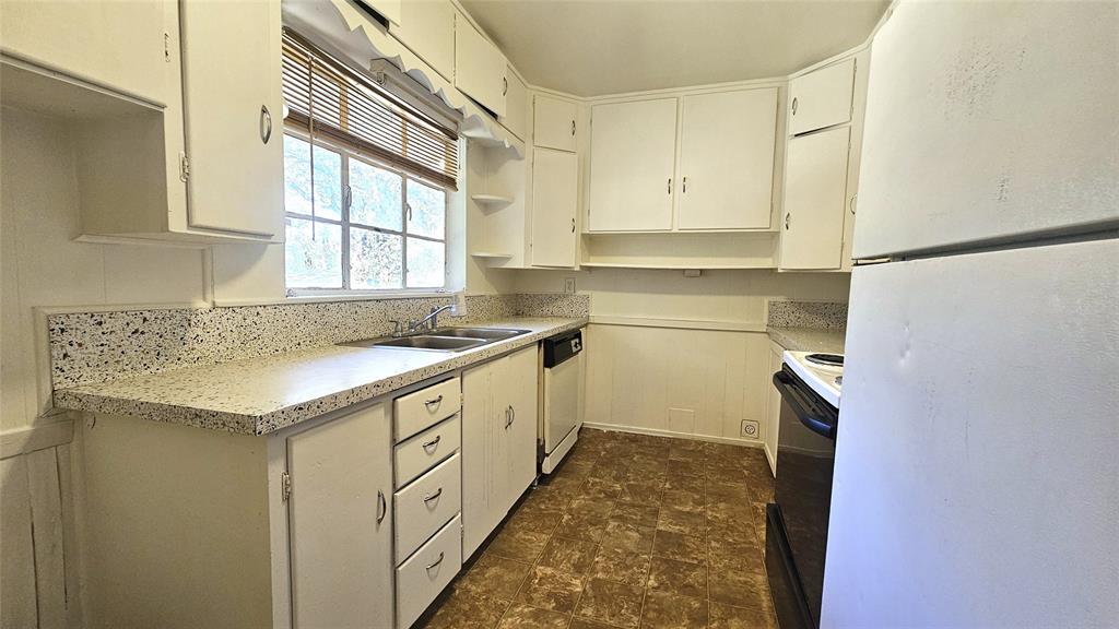 2621 North Locust Street Denton, TX 76209 - Photo 11 of 26 a kitchen with granite countertop a sink and cabinets
