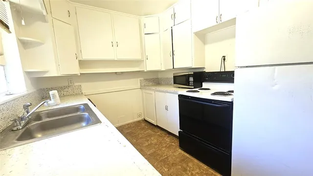 a kitchen with a sink and a stove top oven