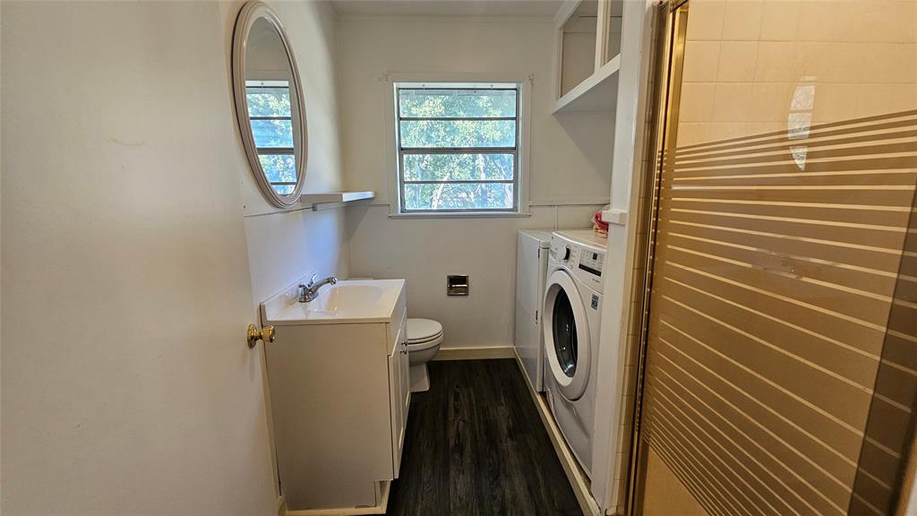 2621 North Locust Street Denton, TX 76209 - Photo 14 of 26 a view of a bathroom with washing machine and a window