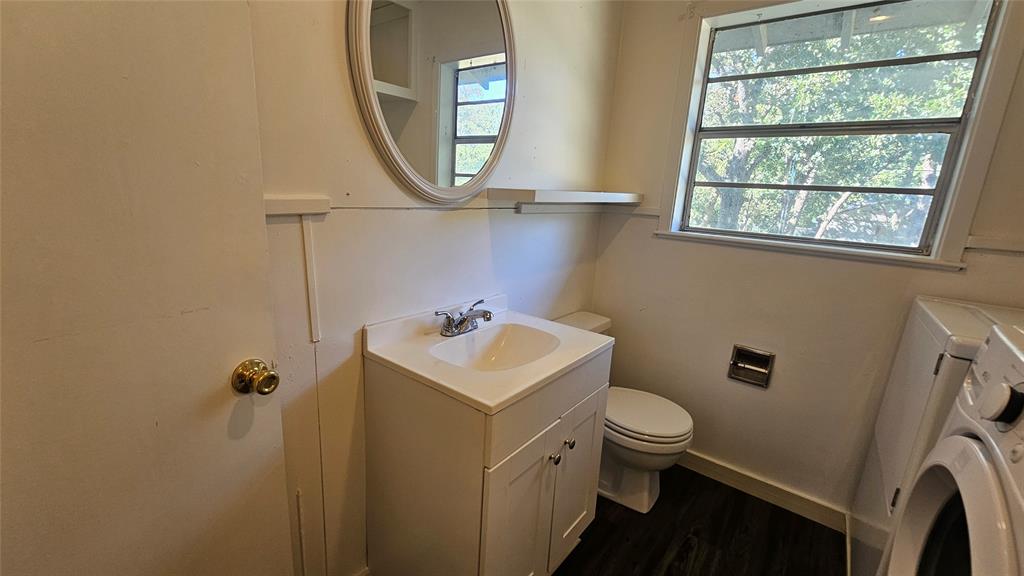 2621 North Locust Street Denton, TX 76209 - Photo 15 of 26 a bathroom with a sink toilet and a mirror