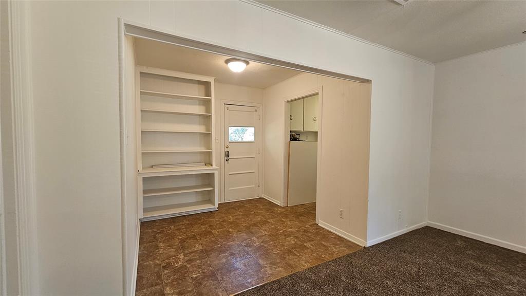 2621 North Locust Street Denton, TX 76209 - Photo 10 of 26 a view of walk in closet with empty racks