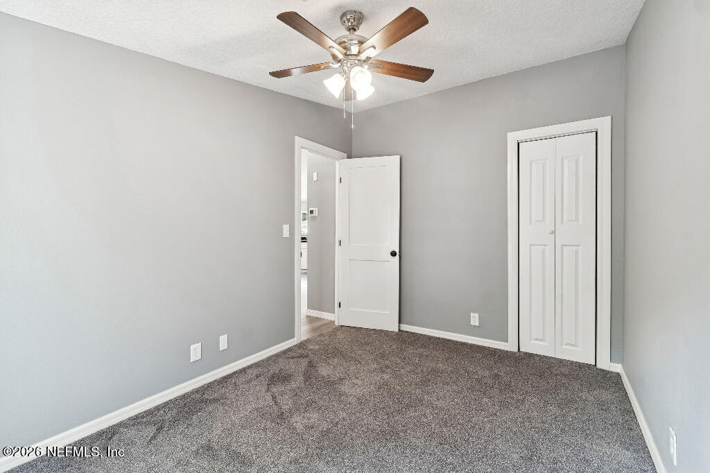 101 Ridgewood Avenue Interlachen, FL 32148 - Photo 16 of 25 an empty room with closet and a ceiling fan