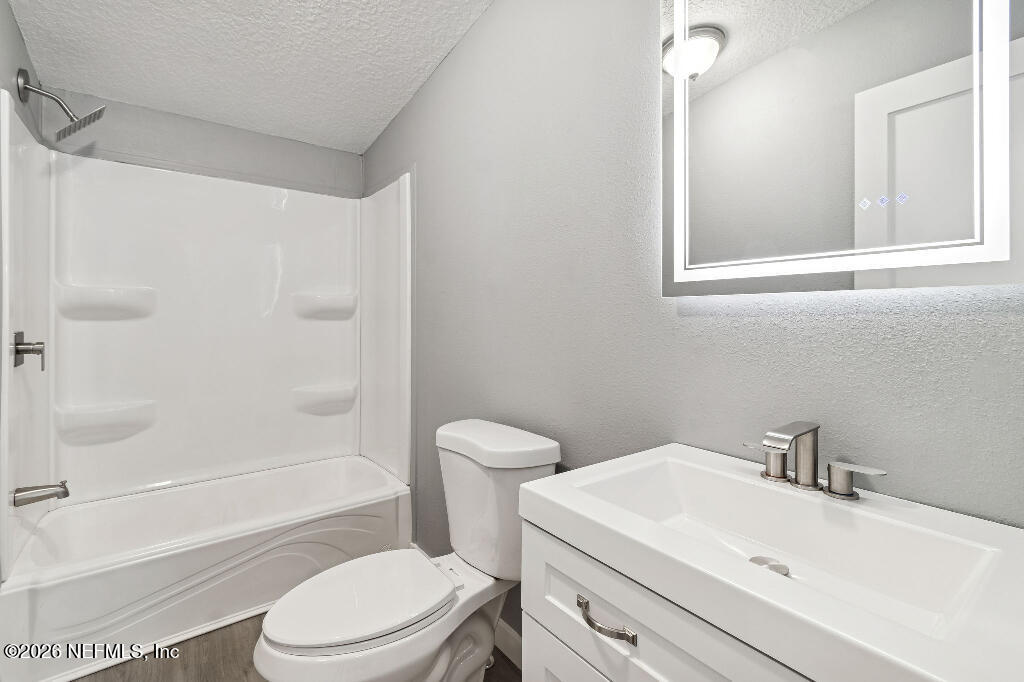 101 Ridgewood Avenue Interlachen, FL 32148 - Photo 17 of 25 a bathroom with a sink a toilet and shower