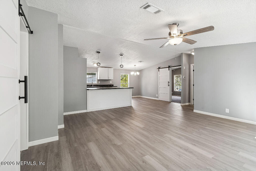 101 Ridgewood Avenue Interlachen, FL 32148 - Photo 3 of 25 a view of a kitchen with a sink and a refrigerator