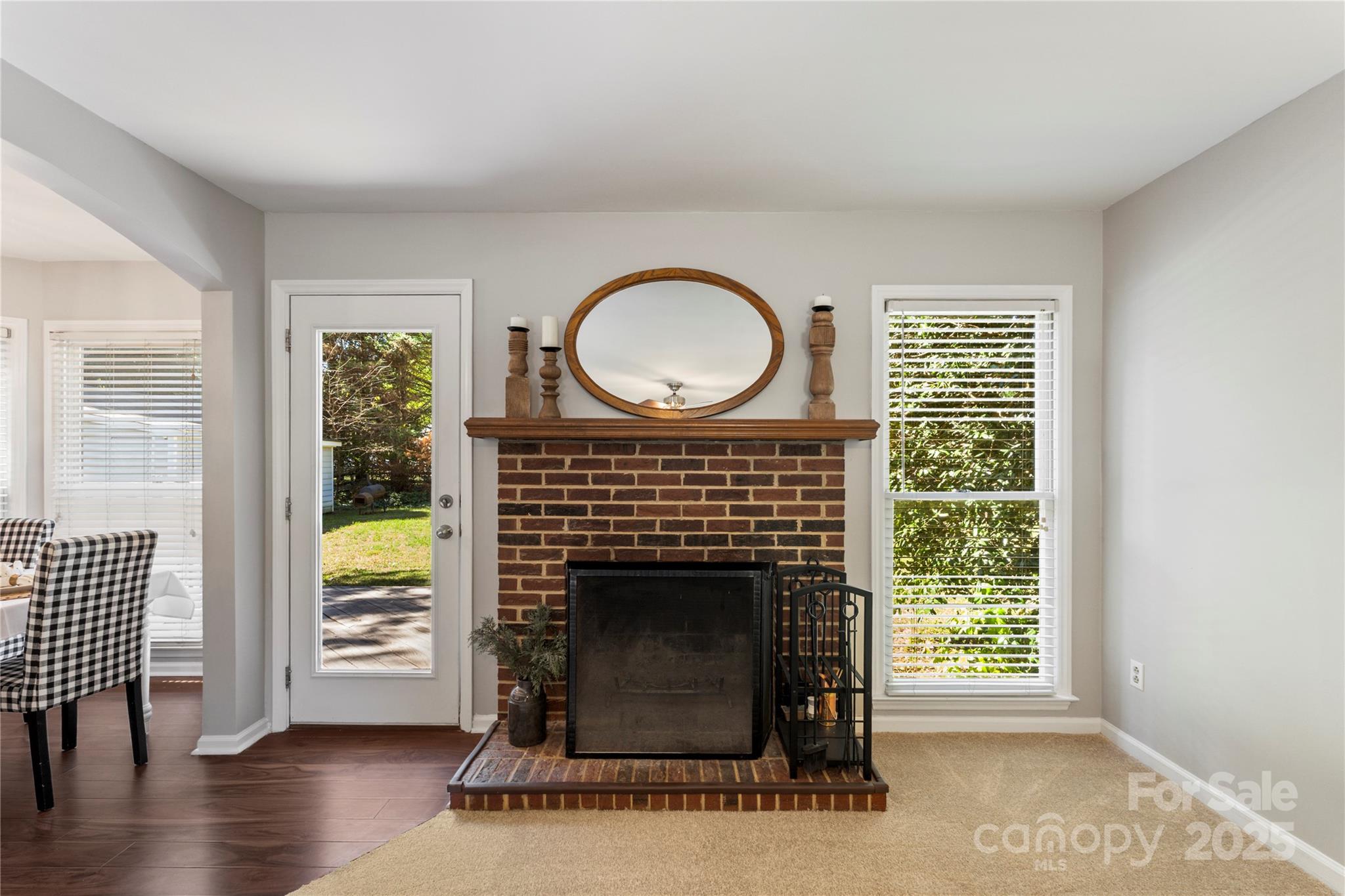 2519 Fitzpatrick Lane Matthews, NC 28105 - Photo 11 of 46 a living room with a fireplace and a wooden floor