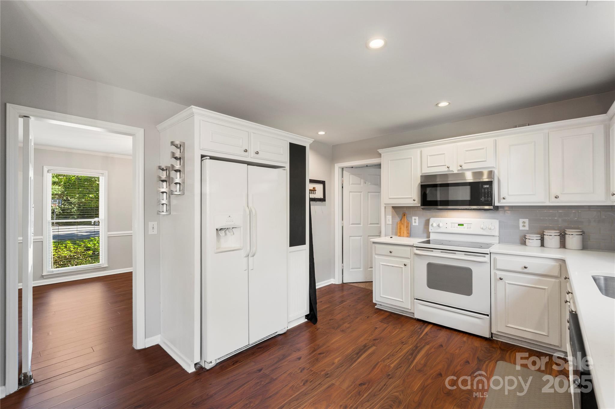 2519 Fitzpatrick Lane Matthews, NC 28105 - Photo 13 of 46 a kitchen with a refrigerator stove and wooden cabinets
