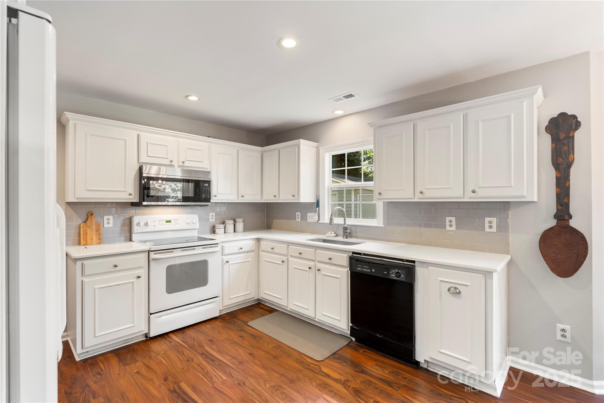 2519 Fitzpatrick Lane Matthews, NC 28105 - Photo 14 of 46 a kitchen with granite countertop white cabinets and white appliances
