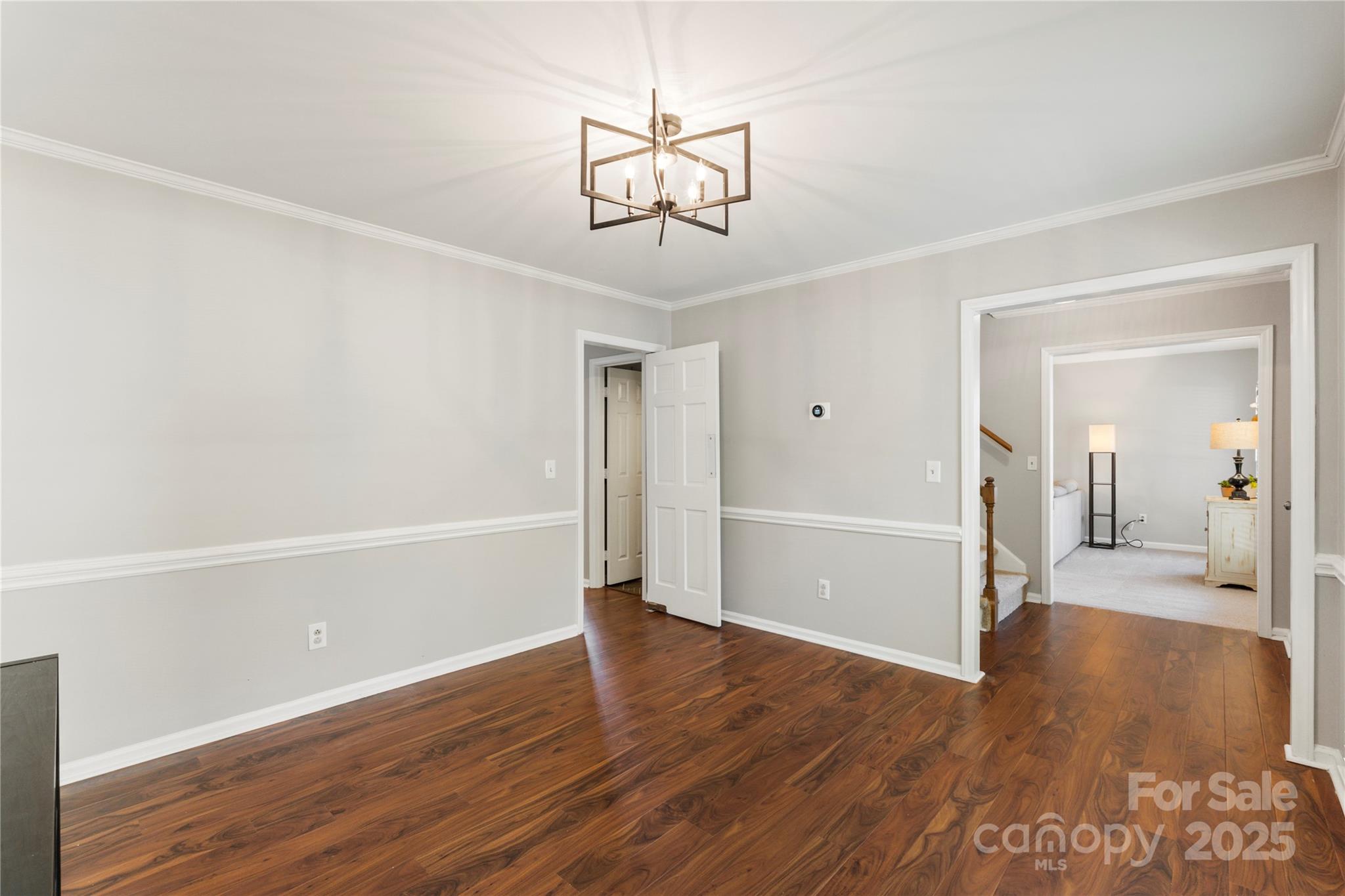 2519 Fitzpatrick Lane Matthews, NC 28105 - Photo 19 of 46 a view of a room with wooden floor and ceiling fan