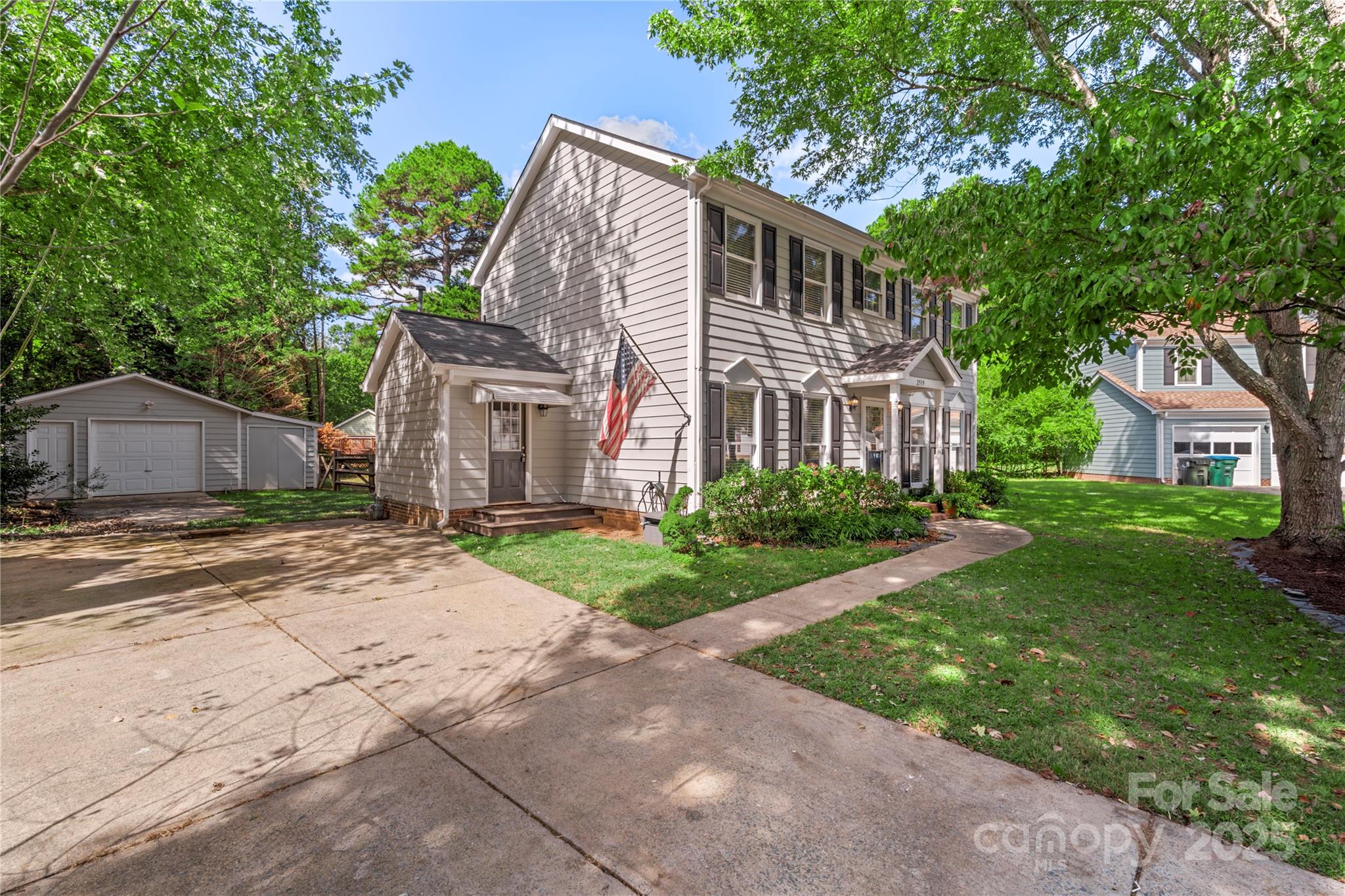 2519 Fitzpatrick Lane Matthews, NC 28105 - Photo 3 of 46 a front view of a house with a garden and trees