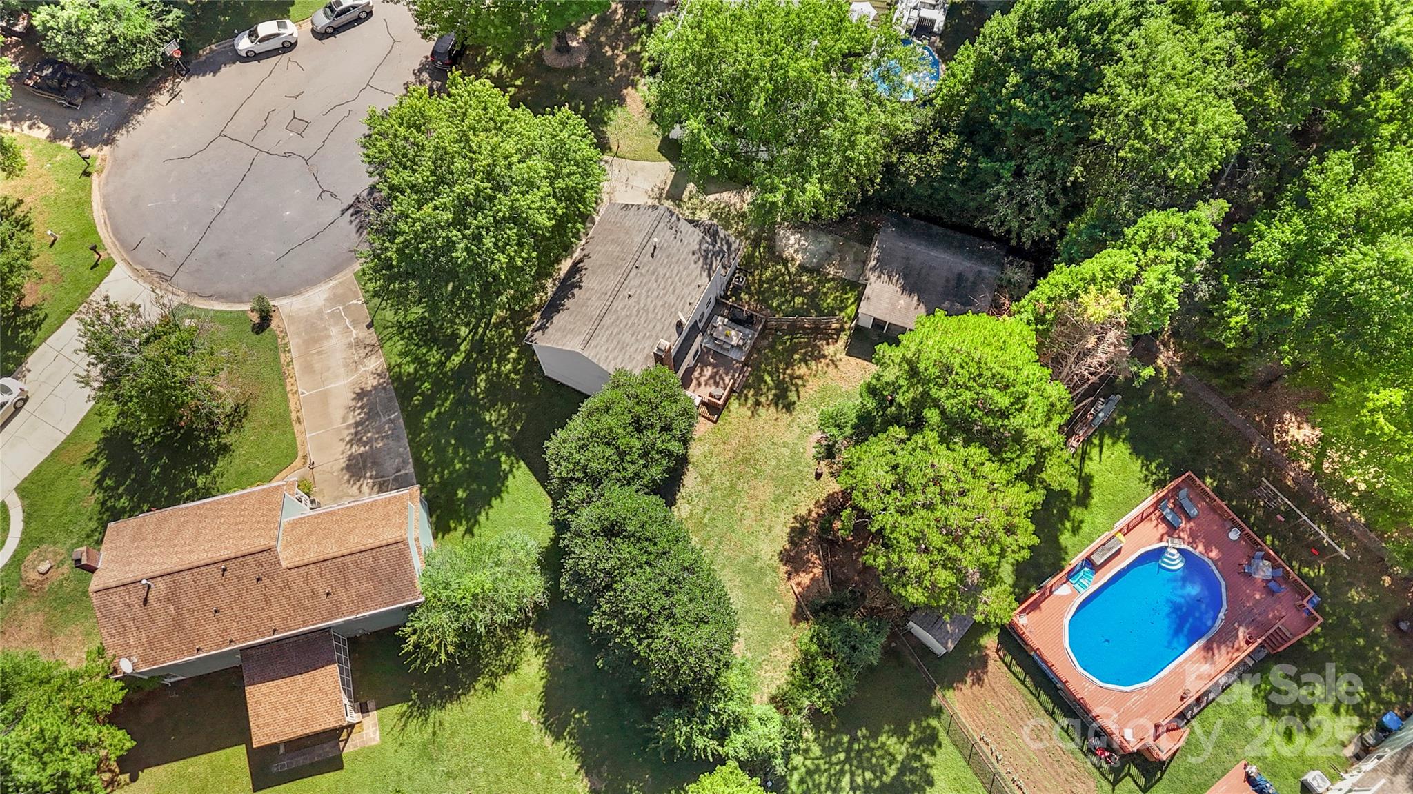 2519 Fitzpatrick Lane Matthews, NC 28105 - Photo 43 of 46 an aerial view of a house with swimming pool and garden