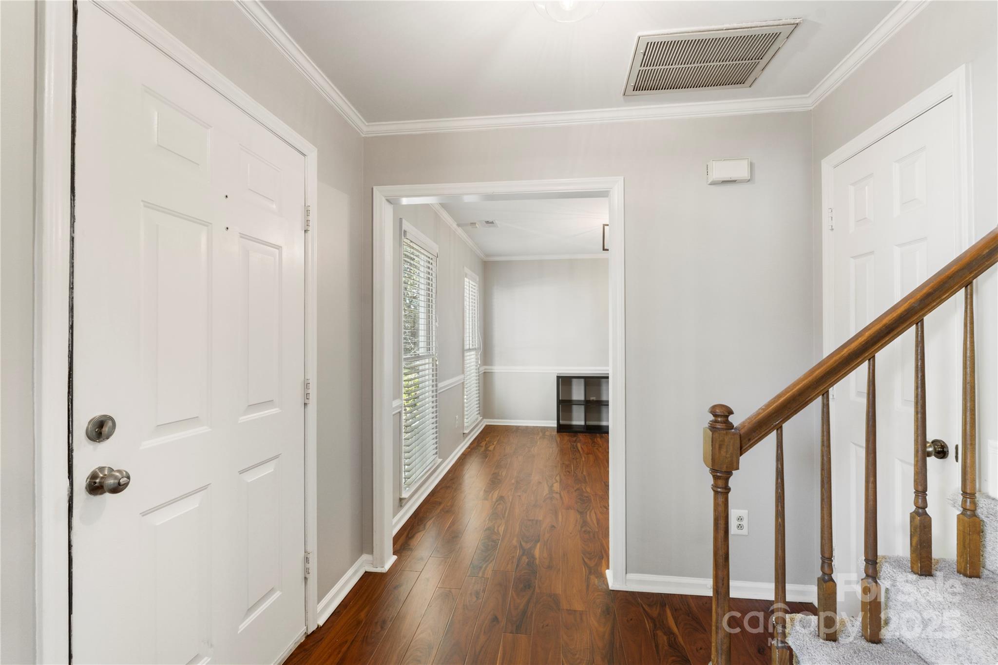 2519 Fitzpatrick Lane Matthews, NC 28105 - Photo 7 of 46 a view of a hallway with wooden floor and staircase