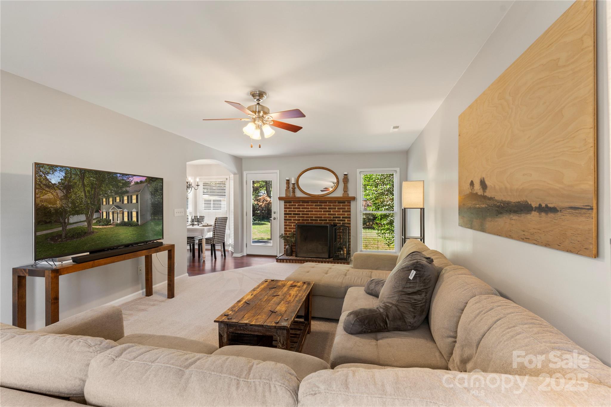 2519 Fitzpatrick Lane Matthews, NC 28105 - Photo 9 of 46 a living room with furniture a fireplace and a flat screen tv