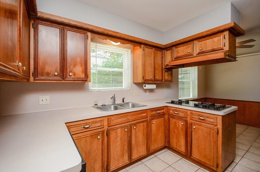 28911 Enchanted Drive Spring, TX 77381 - Photo 3 of 7 a kitchen with stainless steel appliances granite countertop a sink a stove a refrigerator and cabinets