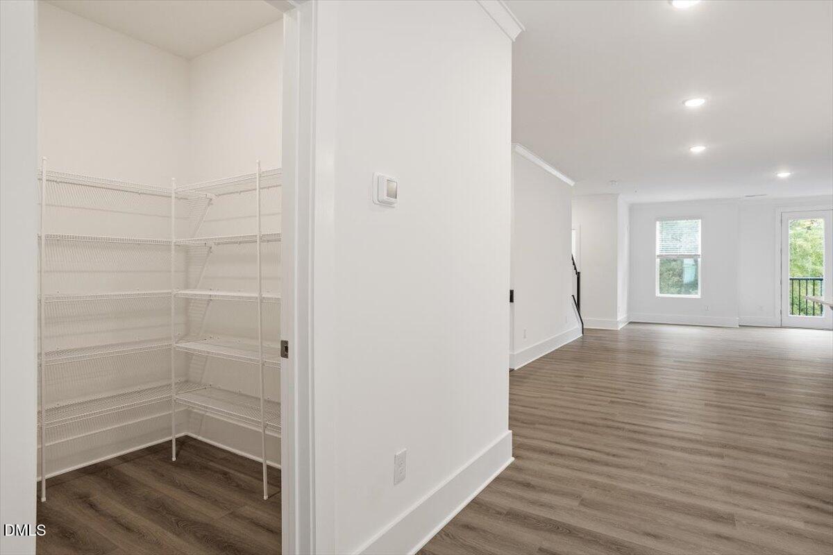 509 Kildaire Farm Road, Unit 302 Cary, NC 27511 - Photo 16 of 30 a view of hallway with window and wooden floor