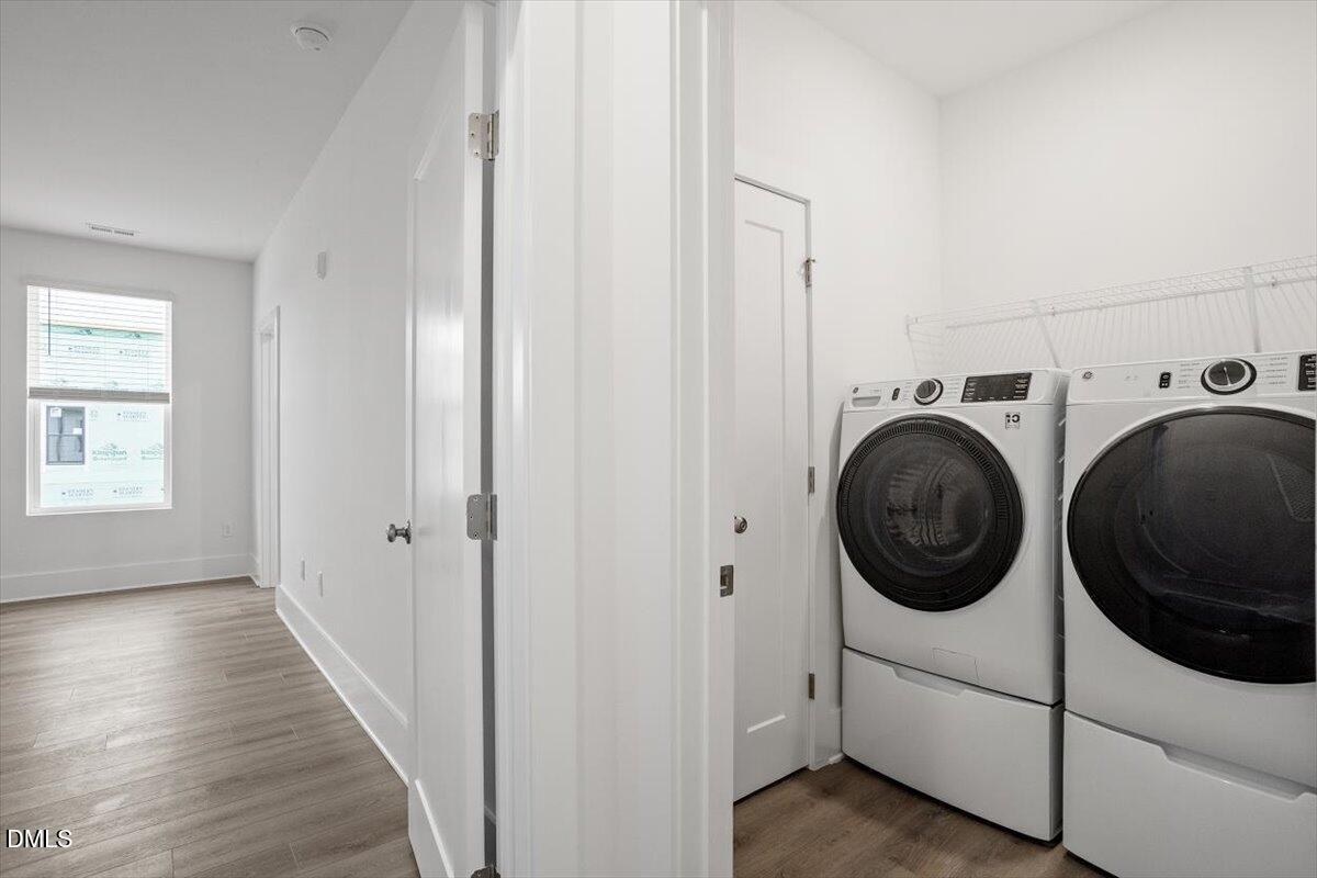 509 Kildaire Farm Road, Unit 302 Cary, NC 27511 - Photo 19 of 30 a view of a hallway with washer and dryer