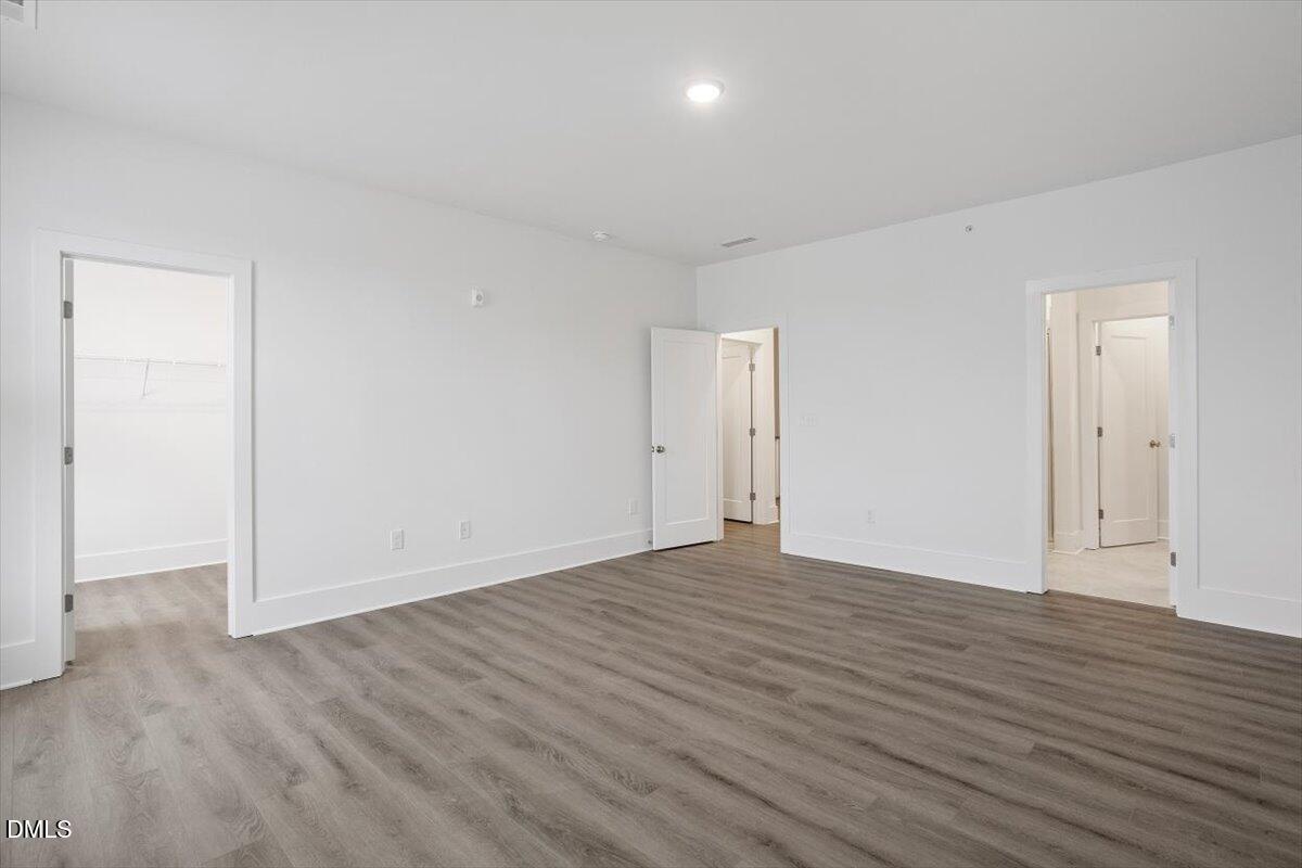 509 Kildaire Farm Road, Unit 302 Cary, NC 27511 - Photo 21 of 30 a view of an empty room with wooden floor
