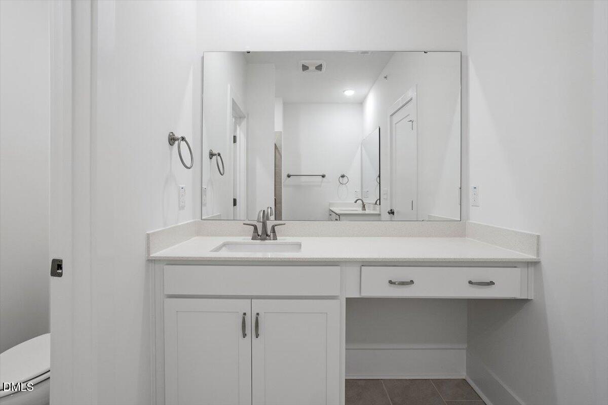 509 Kildaire Farm Road, Unit 302 Cary, NC 27511 - Photo 24 of 30 a bathroom with a sink double vanity and a mirror